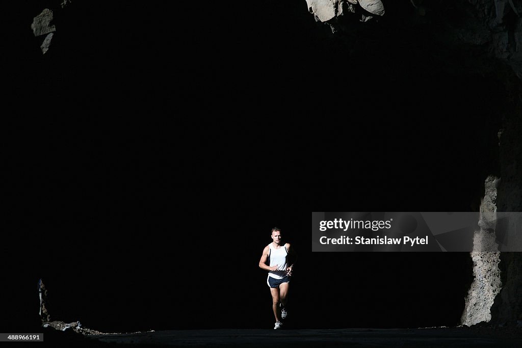 Man running in tunnel