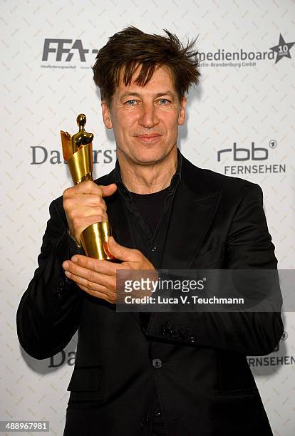 Tobias Moretti poses with his award during the Lola - German Film Award 2014 at Tempodrom on May 9, 2014 in Berlin, Germany.