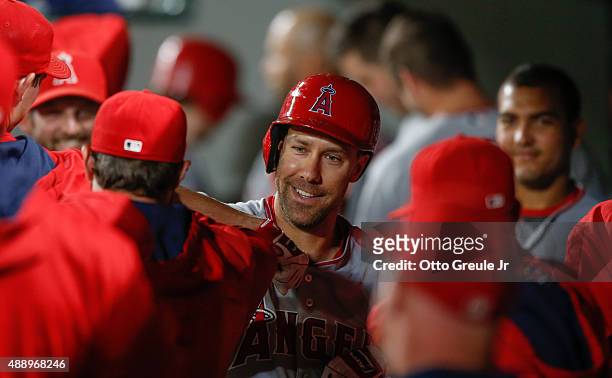 David Murphy of the Los Angeles Angels of Anaheim is congratulated by teammates after hitting a home run against the Seattle Mariners at Safeco Field...