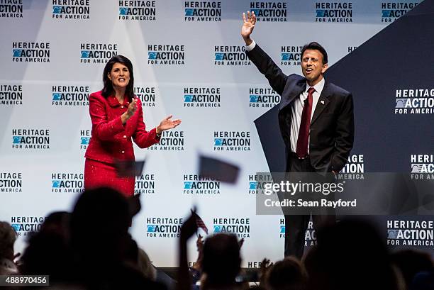 Louisiana Governor Bobby Jindal receives applause from South Carolina Governor Nikki Haley at the Heritage Action Presidential Candidate Forum...