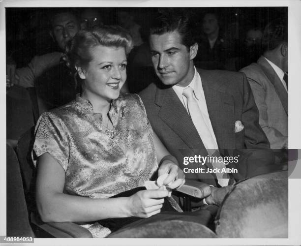 Actress Angela Lansbury with her husband Peter Shaw, attending the premiere of the film 'Flying Leathernecks', 1951.