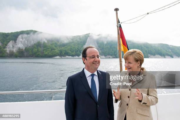 In this handout photo provided by the German Government Press Office , French President Francois Hollande and German Chancellor Angela Merkel are...
