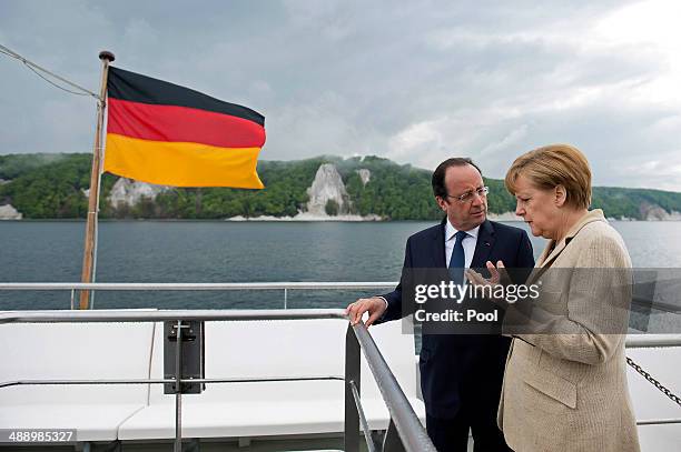 In this handout photo provided by the German Government Press Office , French President Francois Hollande and German Chancellor Angela Merkel are...