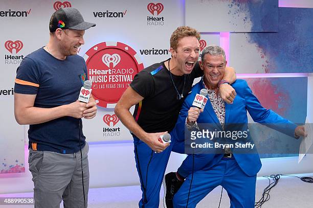 Presenter Elvis Duran interviews musicians Johnny Buckland and Chris Martin of Coldplay during the 2015 iHeartRadio Music Festival at MGM Grand...