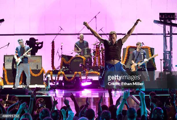 Musicians Jonny Buckland, Will Champion, Chris Martin and Guy Berryman of Coldplay perform onstage at the 2015 iHeartRadio Music Festival at MGM...