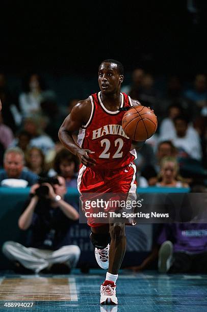 Brevin Knight of the Atlanta Hawks brings the ball upcourt during the game against the Charlotte Hornets on April 16, 2001 at Charlotte Coliseum in...