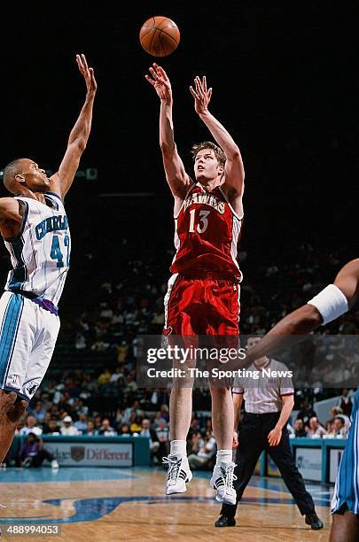 Hanno Mottola of the Atlanta Hawks puts a shot up over David Wesley of the Charlotte Hornets during the game on April 16, 2001 at Charlotte Coliseum...