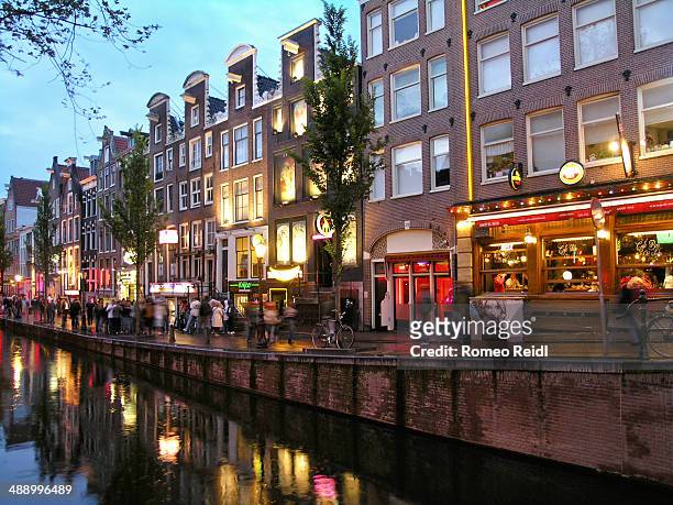 red light district street scene in amsterdam - red light district stock pictures, royalty-free photos & images