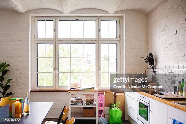 window into sunny white european kitchen - bay window interior stock pictures, royalty-free photos & images