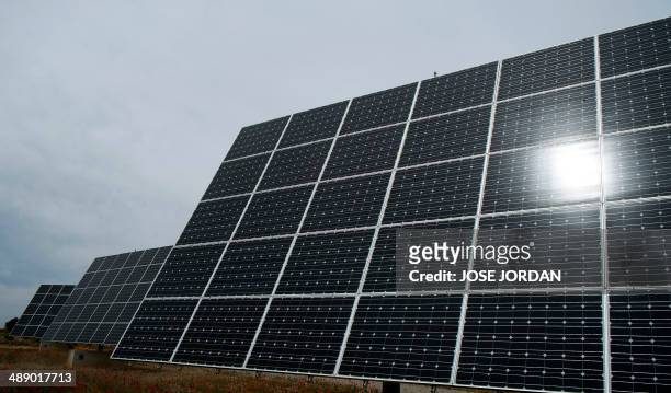 The sun is reflected in a solar panel in a field of Mahora, near eastern Spanish city of Albacete on May 7, 2014. Spanish people who installed solar...