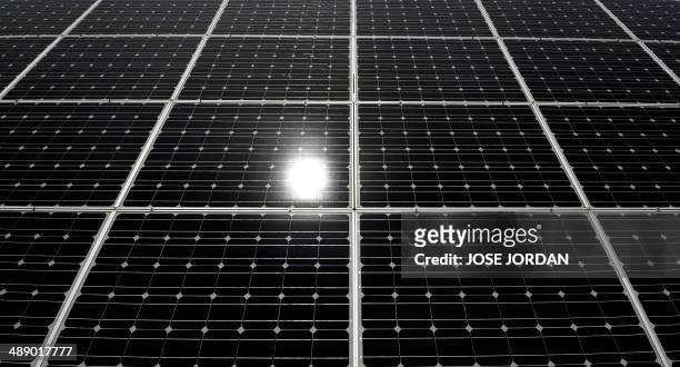 The sun is reflected in a solar panel in a field of Mahora, near eastern Spanish city of Albacete on May 7, 2014. Spanish people who installed solar...