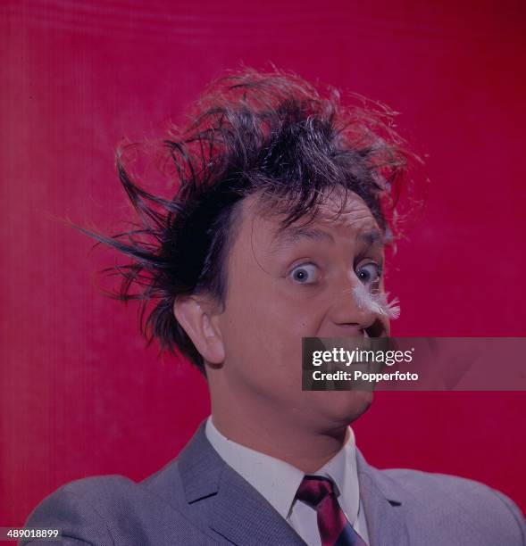 Portrait of English comedian Ken Dodd as he appears on the television series 'Doddy's Music Box' in 1966.