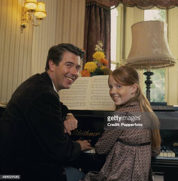 English comedian and television host Leslie Crowther posed at home with his daughter, actress Liz Crowther in 1967.
