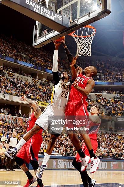 Ian Mahinmi of the Indiana Pacers shoots against Paul Millsap of the Atlanta Hawks in Game Five of the East Conference Quarter Finals of the 2014 NBA...