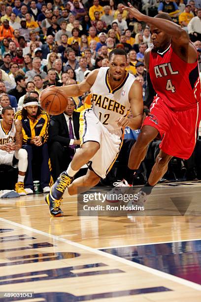 Evan Turner of the Indiana Pacers drives against Paul Millsap of the Atlanta Hawks in Game Five of the East Conference Quarter Finals of the 2014 NBA...