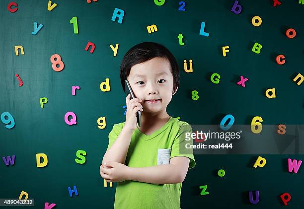 boy using smart phone - number magnet stock pictures, royalty-free photos & images