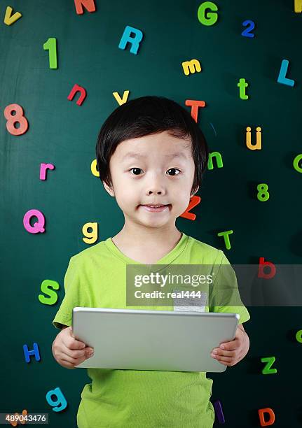 boy with tablet - number magnet stock pictures, royalty-free photos & images