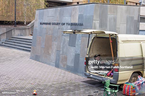 Young man sleeping in the back of his truck at the Salamanca Market in front of the Supreme Court of Tasmania