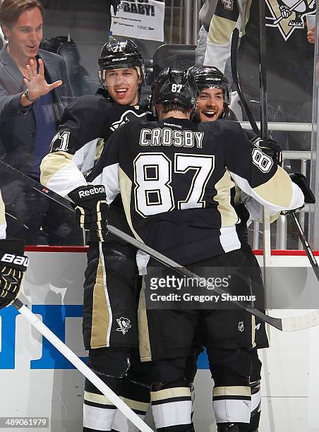Evgeni Malkin celebrates his goal with Sidney Crosby and Kris Letang of the Pittsburgh Penguins during the second period against the New York Rangers...