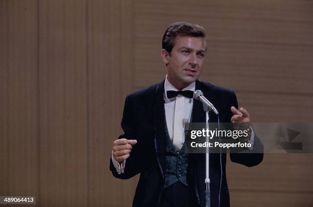 English comedian and singer Des O'Connor performs on stage at the Palladium Show in London in 1968.