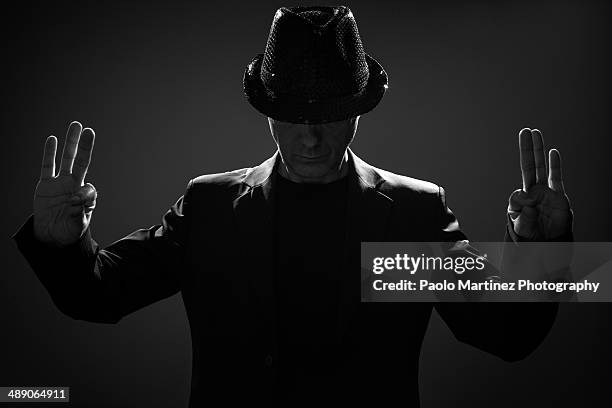 magician in the shadows - magician hat stock-fotos und bilder