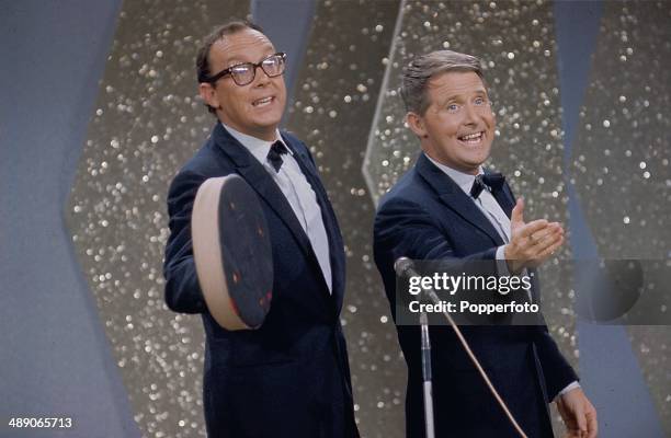 Eric Morecambe and Ernie Wise of English comic double act Morecambe and Wise perform on stage at the Palladium Show in London in 1968.