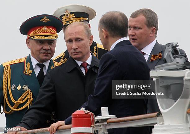 Russian President Vladimir Putin and Defence Minister Sergei Shoigu attend a Victory Day parade May 9, 2014 in Sevastopol, a city in the Crimean...