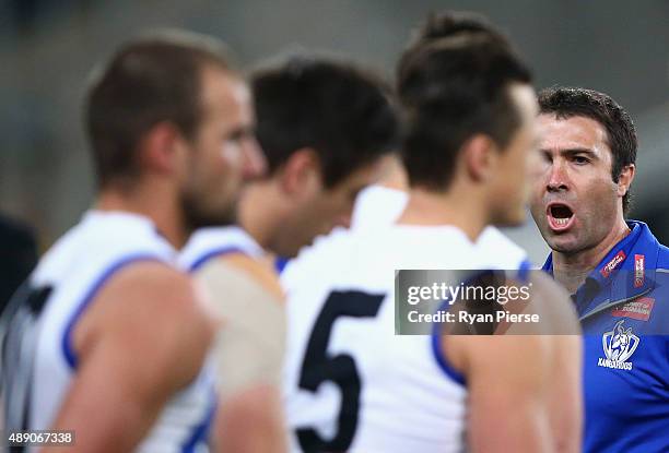 Brad Scott, coach of the Kangaroos, talks to his players during the First AFL Semi Final match between the Sydney Swans and the North Melbourne...