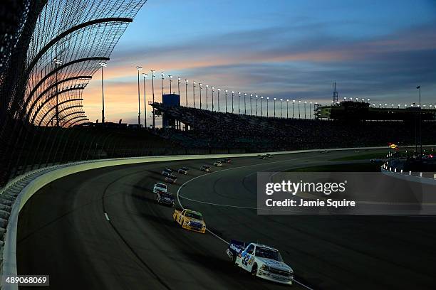 Tayler Malsam, driver of the Outerwall Chevrolet, leads a pack of trucks during the NASCAR Camping World Truck Series SFP 250 at Kansas Speedway on...