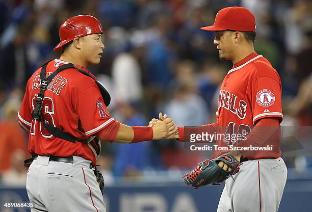 Ernesto Frieri and Hank Conger of the Los Angeles Angels of Anaheim celebrate a victory during MLB game action against the Toronto Blue Jays on May...