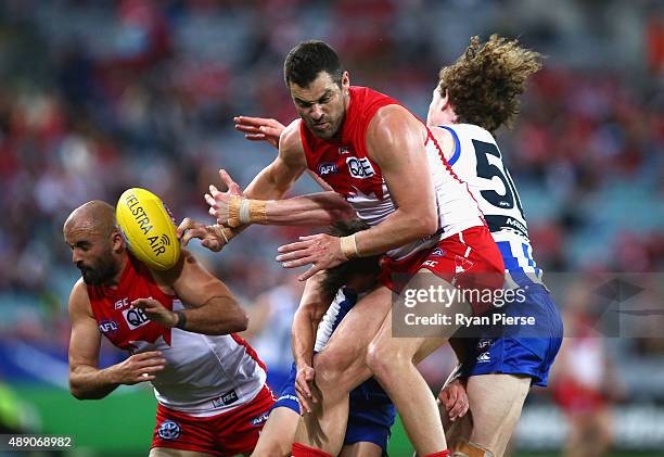 Heath Grundy and Rhyce Shaw of the Swans spoil the ball during the First AFL Semi Final match between the Sydney Swans and the North Melbourne...