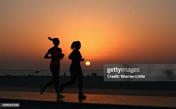 Runners jog along the recently refurbished Kite Beach is pictured on September 14, 2015 in Dubai, United Arab Emirates. The Beach is very popular...
