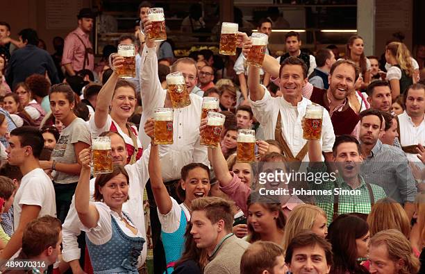 Revelers raise their beer glasses at the Paulaner beer tent on the opening day of the 2015 Oktoberfest on September 19, 2015 in Munich, Germany. The...