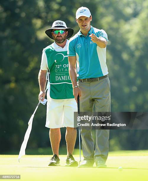 Martin Kaymer of Germany and his caddie Craig Connelly line up a putt on the second hole during the third round of the 72nd Open d'Italia at Golf...