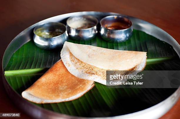 Plate of dosa, a pancake of fermented rice and black lentils served alongside various chutneys at the Visalam Hotel in Kanadukathan village in...