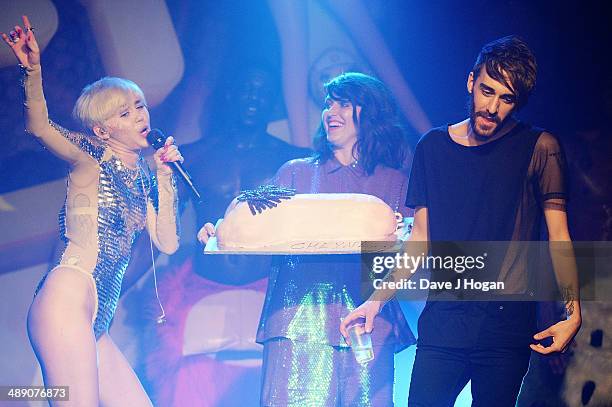 Miley Cyrus performs while a cake is brought out for her friend, Cheyne Thomas at G-A-Y on May 9, 2014 in London, England.