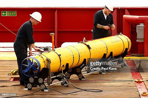 Technicians tie down the Bluefin-21 autonomous underwater vehicle prior to the ADV Ocean Shield slipping from the wharf at HMAS Stirling on May 10,...