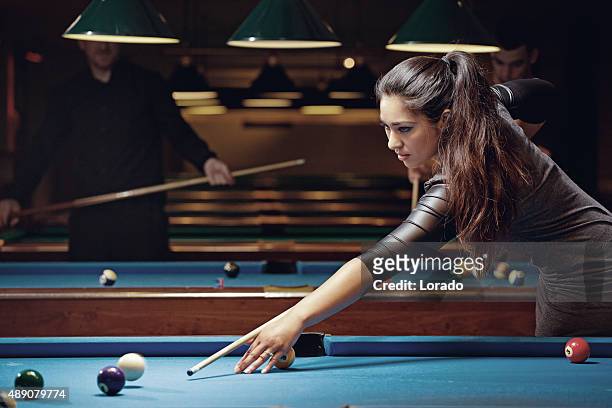 group of friends playing pool in a local pool hall - competition group stock pictures, royalty-free photos & images