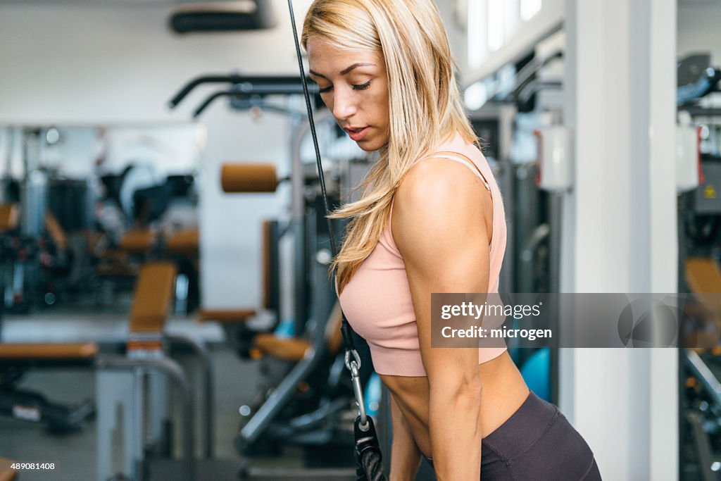 Triceps exercise on cable gym machine