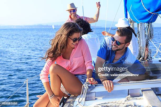 young couple enjoying a boat ride together - boat deck stock pictures, royalty-free photos & images