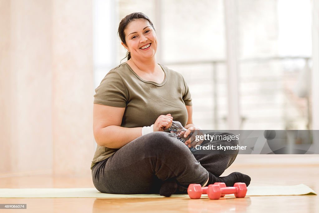 Overweight woman taking a break from exercising.