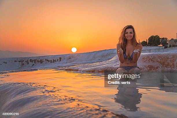 young woman enjoying pamukkale, turkey at sunset time - pamukkale stock pictures, royalty-free photos & images