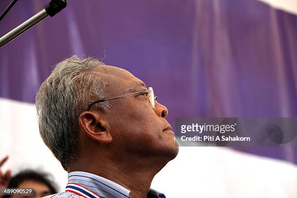 Anti-government protesters leader Suthep Thaugsuban greets his supporters during a rally outside Government House in Bangkok. Thai protesters marched...