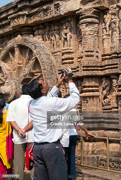 Tourists at the mid-13th century Sun Temple in Konark, India, built in the shape of a chariot for the sun god Surya.