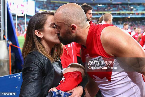 Rhyce Shaw of the Swans greets his wife Leah after being chaired from the ground after his last AFL match during the First AFL Semi Final match...