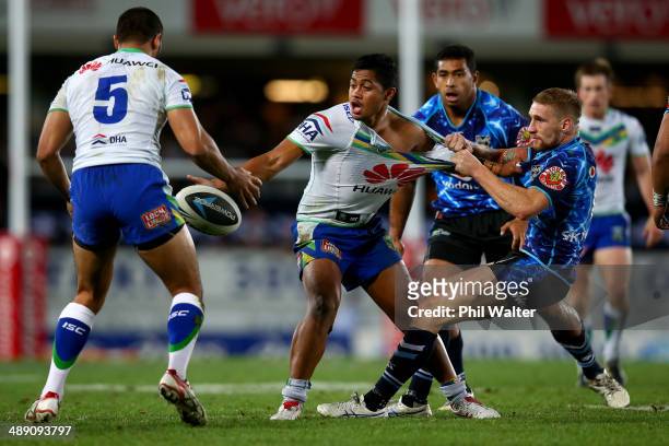 Anthony Milford of the Raiders is tackled by Sam Tomkins of the Warriors during the round nine NRL match between the New Zealand Warriors and the...