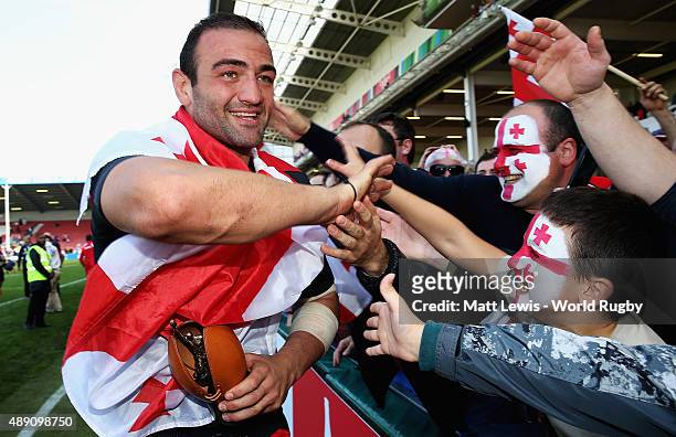 Mamuka Gorgodze of Georgia celebrates his teams win with fans after the 2015 Rugby World Cup Pool C match between Tonga and Georgia at Kingsholm...
