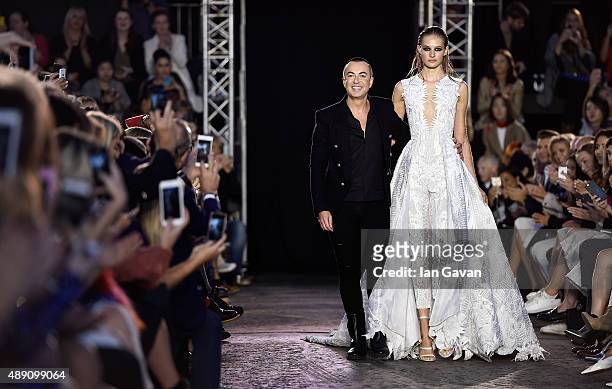 Julien Macdonald and a model on the runway at the Julien Macdonald show during London Fashion Week Spring/Summer 2016 on September 19, 2015 in...