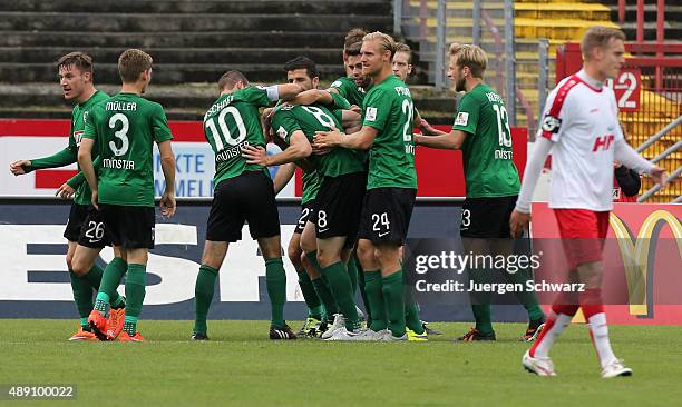 Marc Heitmeier of Muenster celebrates with teammates after scoring during the Third League match between Preussen Muenster and Fortuna Koeln at...