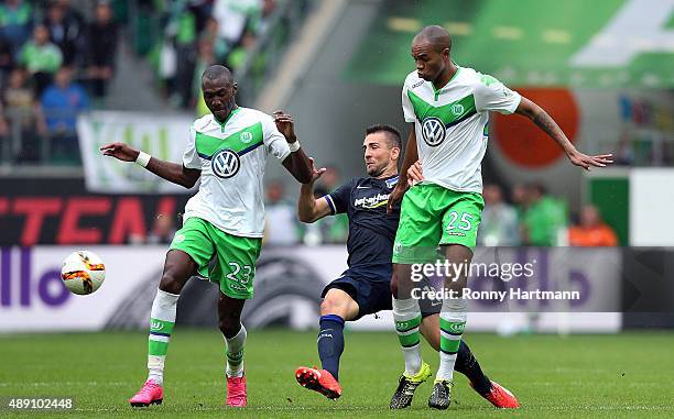 Vedad Ibisevic of Berlin is attacked by Josuha Guilavogui and Naldo of Wolfsburg during the Bundesliga match between VfL Wolfsburg and Hertha BSC at...